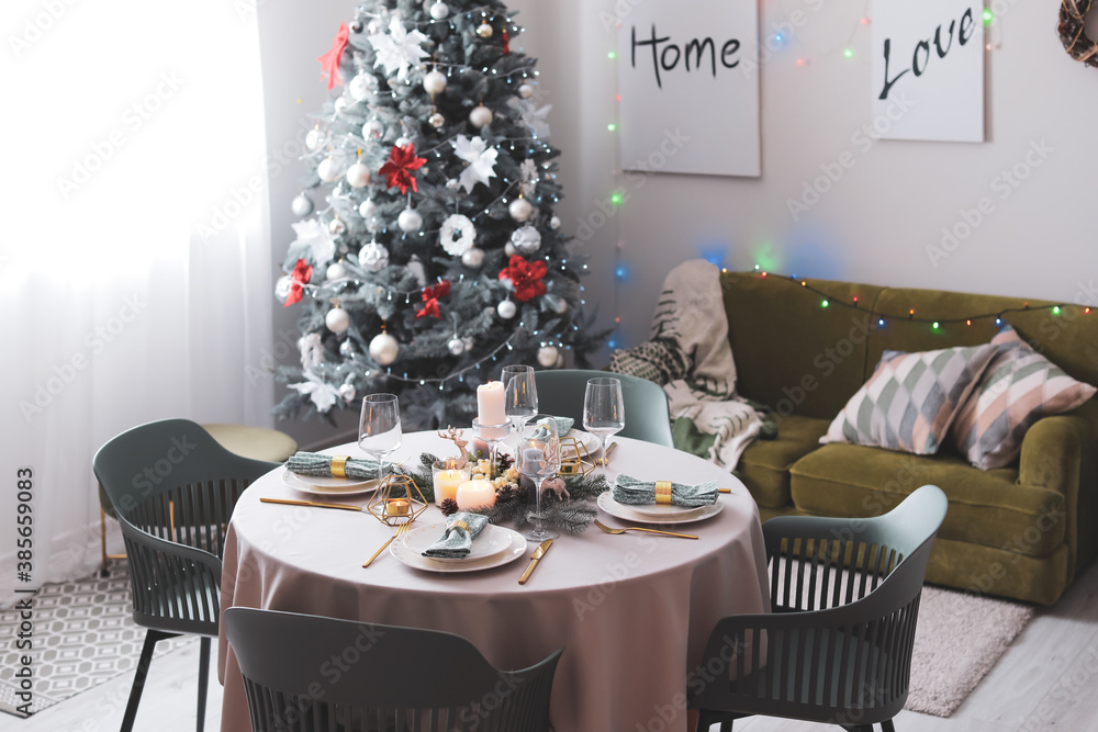 Interior of room with table set for Christmas dinner