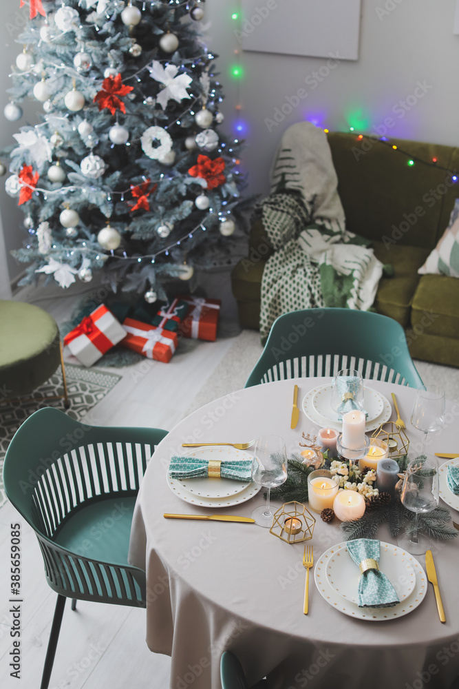 Interior of room with table set for Christmas dinner