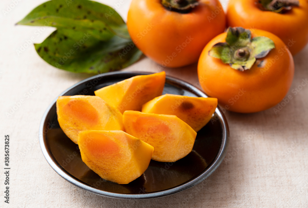 Cut Japanese persimmons on a plate