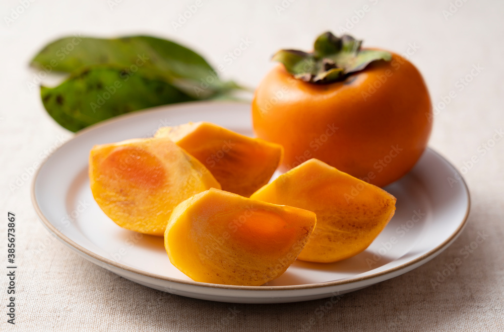 Cut Japanese persimmons on a plate