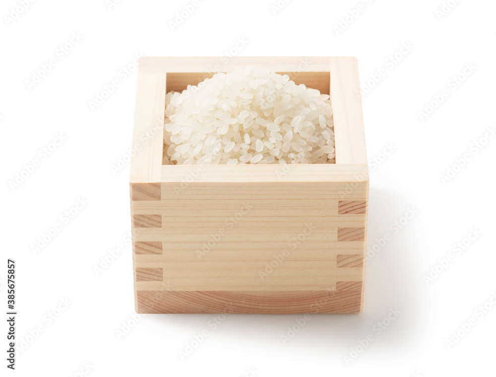 Rice in a measuring cup on a white background