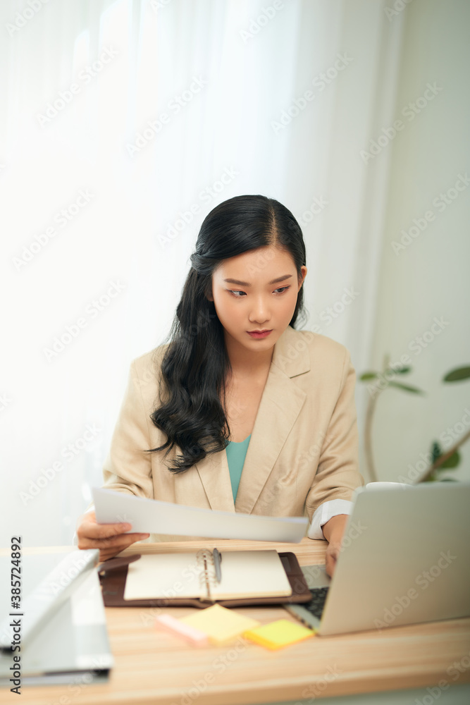 Asian businesswoman mother working at home with notebook computer. Concept for home based work.