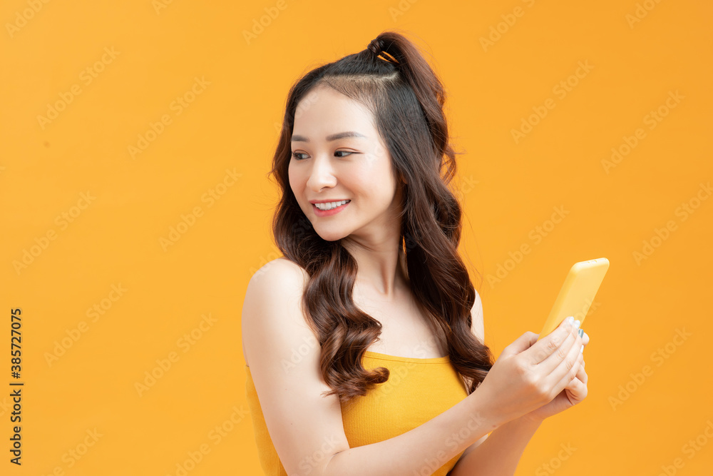 Pretty young woman turning to look back over her shoulder with a happy smile