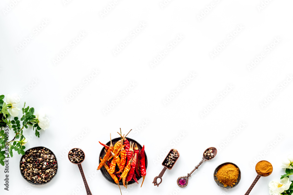 Kitchen utensils with spice and herbs in metal bowls, overhead