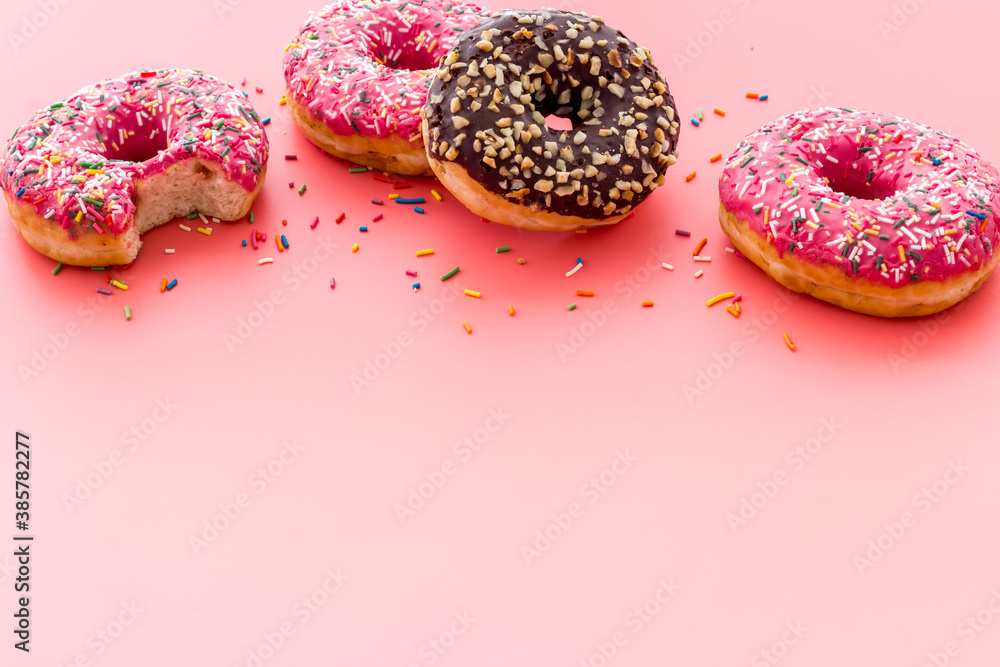 Colorful donuts close up, glazed and sprinkles bakery