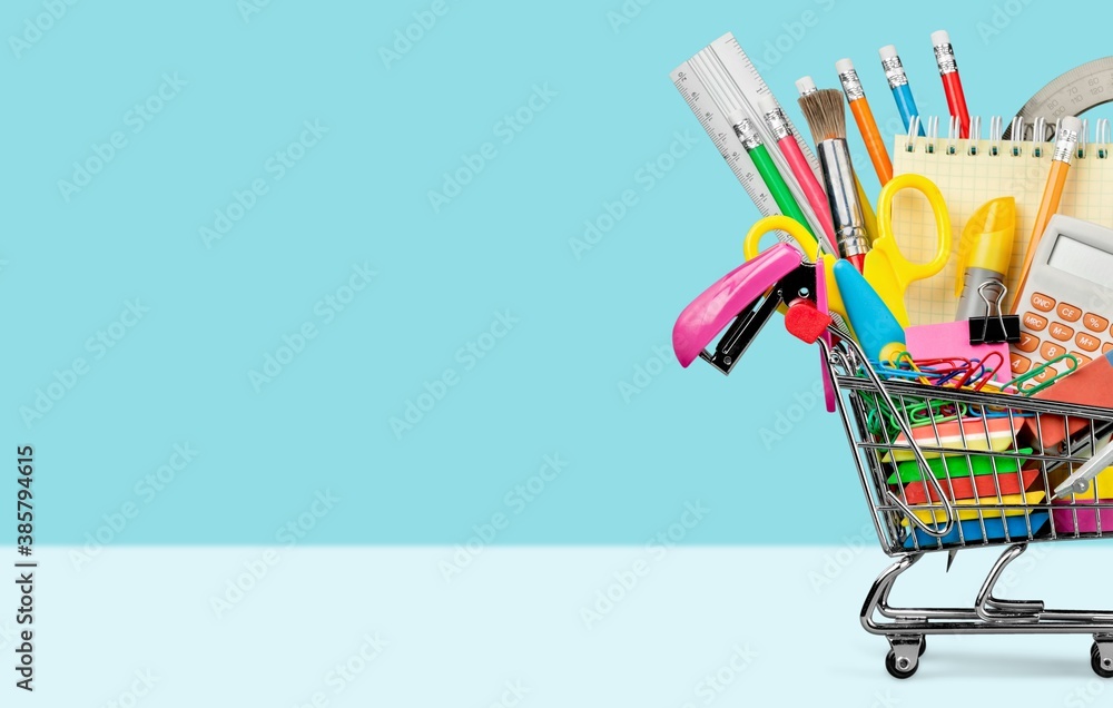 Stationery objects in mini supermarket cart on desk