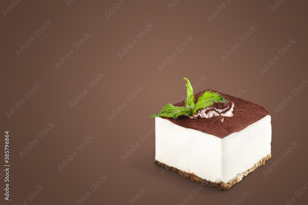 Slice of delicious dessert served on a colored background