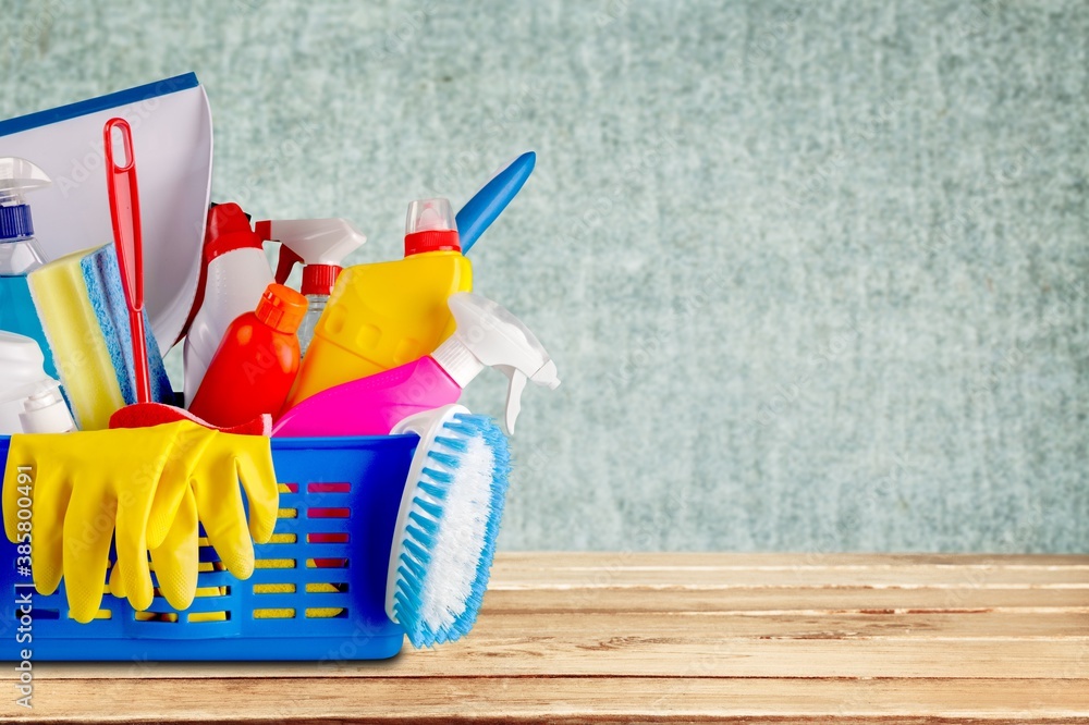 Plastic bottles, cleaning sponges and gloves in bucket