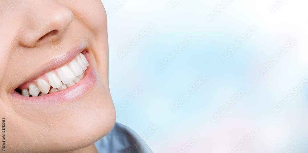 Beautiful smile of young woman with healthy white teeth