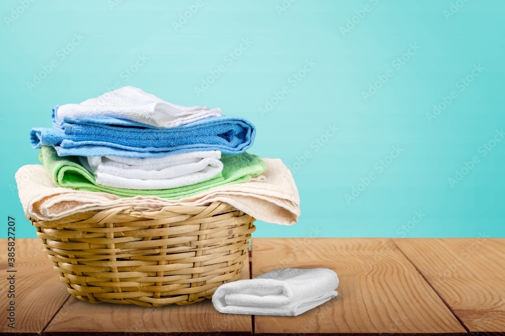 Laundry basket with colorful towels on desk