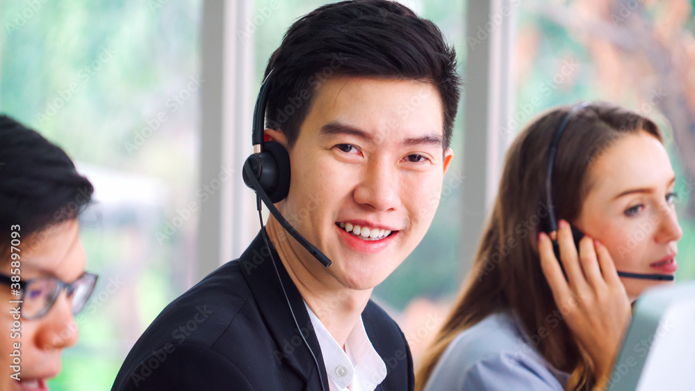 Business people wearing headset working in office to support remote customer or colleague. Call cent