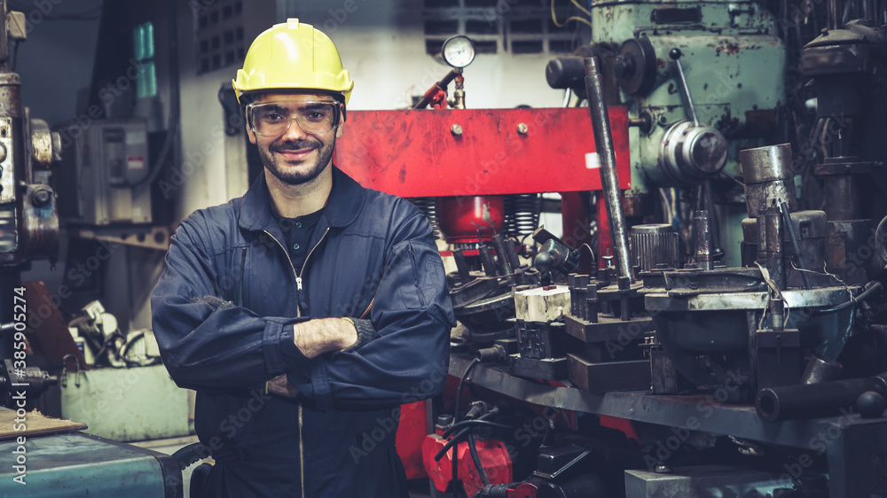 Young factory worker or engineer close up portrait in factory . Industry and engineering concept .