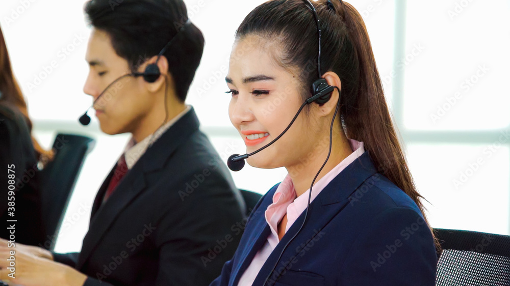 Business people wearing headset working in office to support remote customer or colleague. Call cent