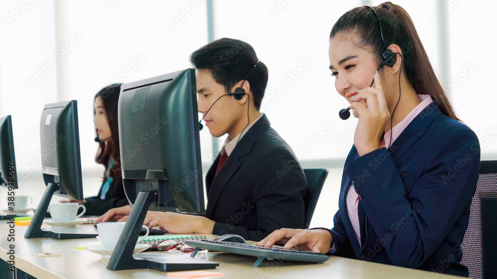 Business people wearing headset working in office to support remote customer or colleague. Call cent