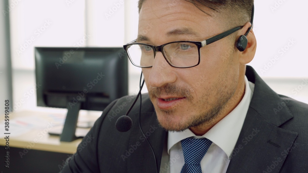 Business people wearing headset working in office to support remote customer or colleague. Call cent