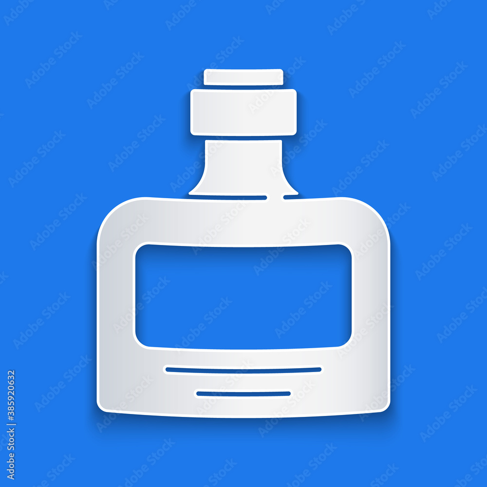 Paper cut Whiskey bottle icon isolated on blue background. Paper art style. Vector.