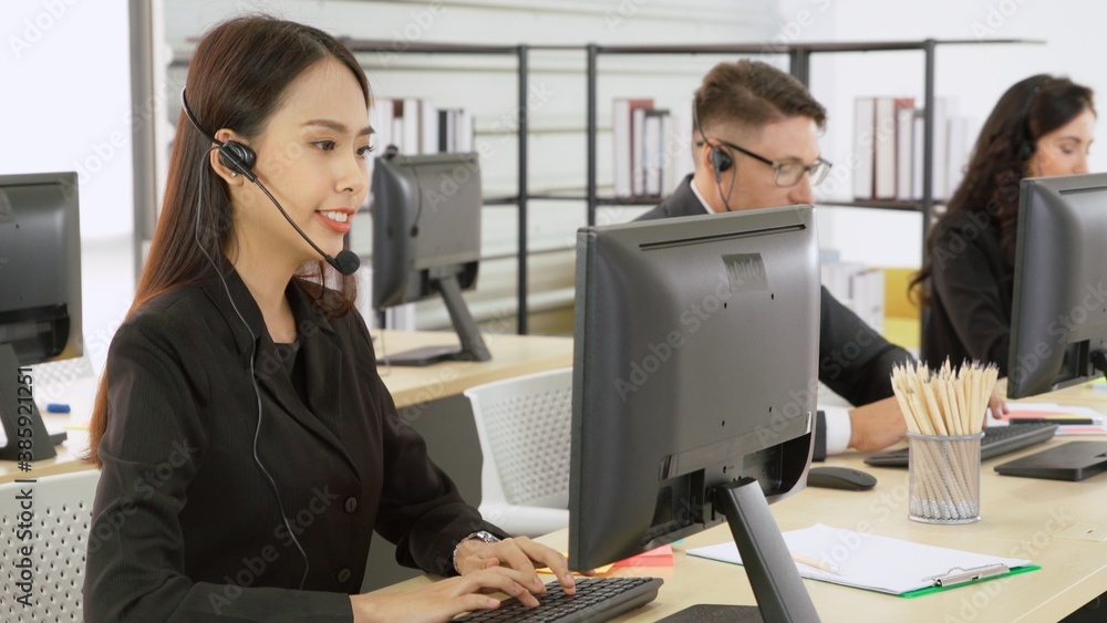 Business people wearing headset working in office to support remote customer or colleague. Call cent