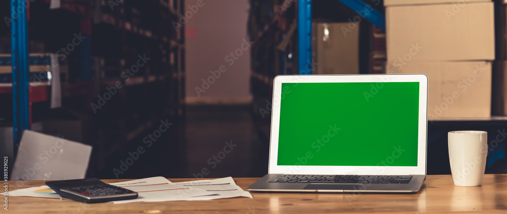 Computer with green screen display in warehouse storage room . Delivery and transportation software 