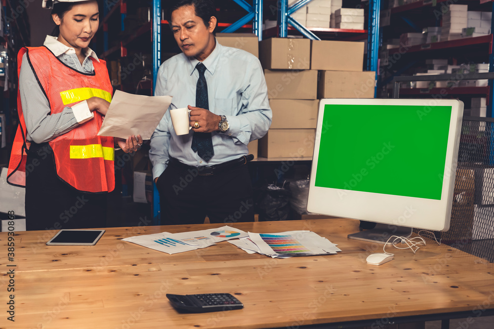 Computer with green screen display in warehouse storage room . Delivery and transportation software 