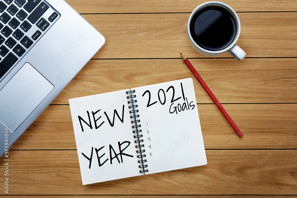 2021 Happy New Year Resolution Goal List - Business office desk with notebook written in handwriting