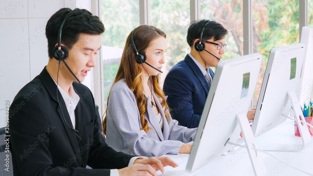 Business people wearing headset working in office to support remote customer or colleague. Call cent