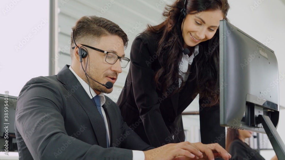 Business people wearing headset working in office to support remote customer or colleague. Call cent