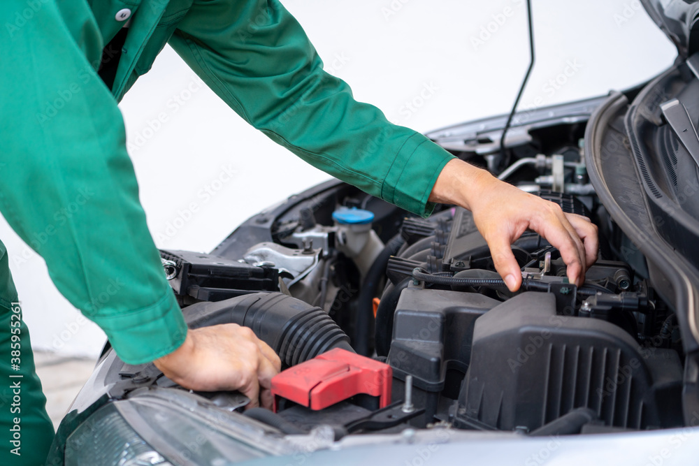 Professional mechanic hand providing car repair and maintenance service in auto garage. Car service 