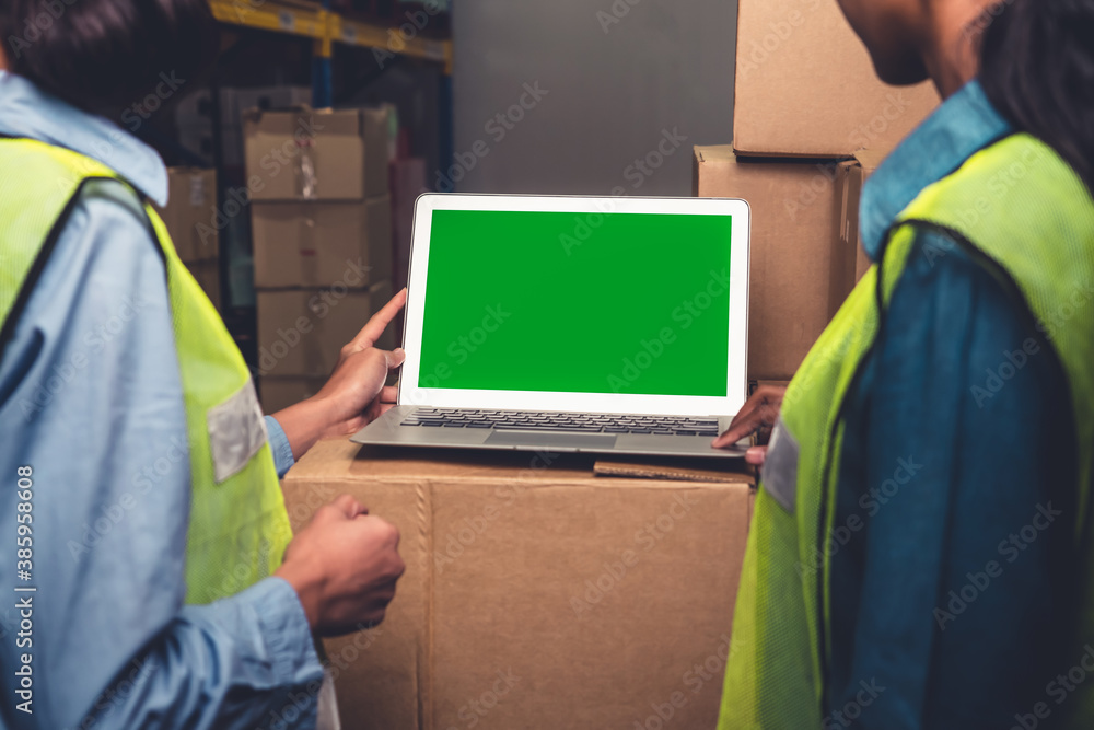 Computer with green screen display in warehouse storage room . Delivery and transportation software 