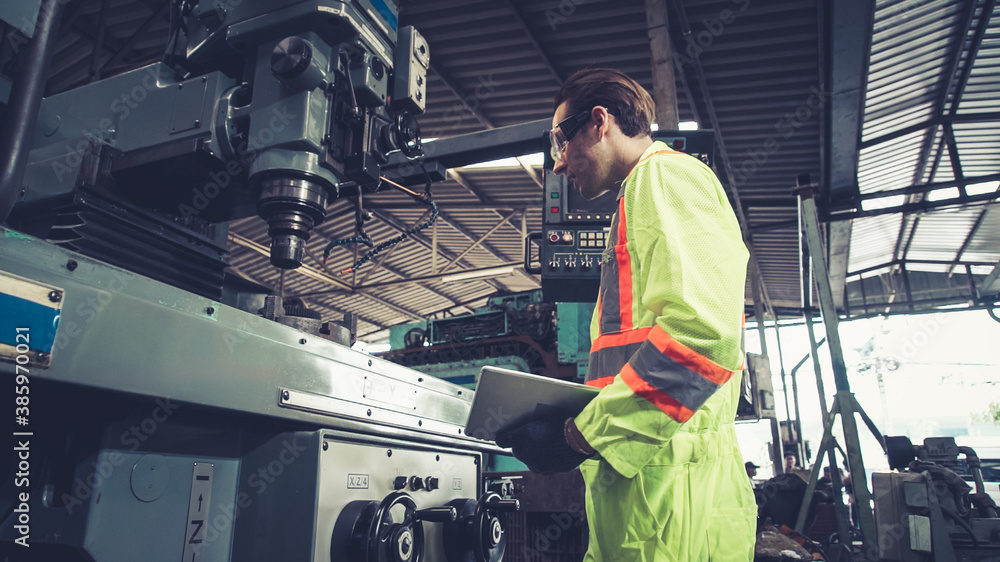 Smart factory worker using machine in factory workshop . Industry and engineering concept.