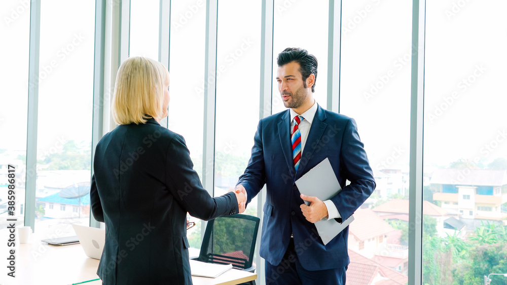 Business people handshake in corporate office showing professional agreement on a financial deal con