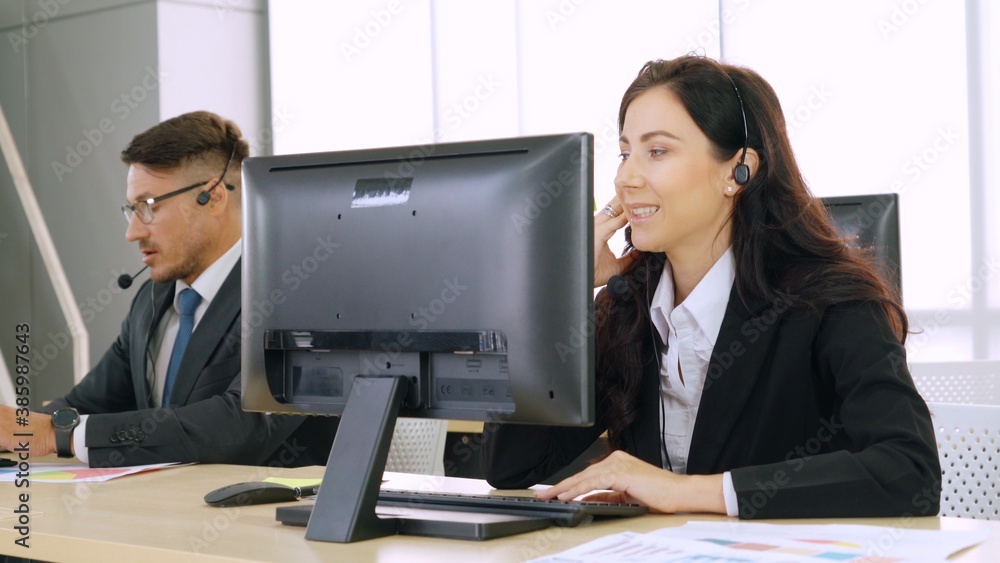 Business people wearing headset working in office to support remote customer or colleague. Call cent