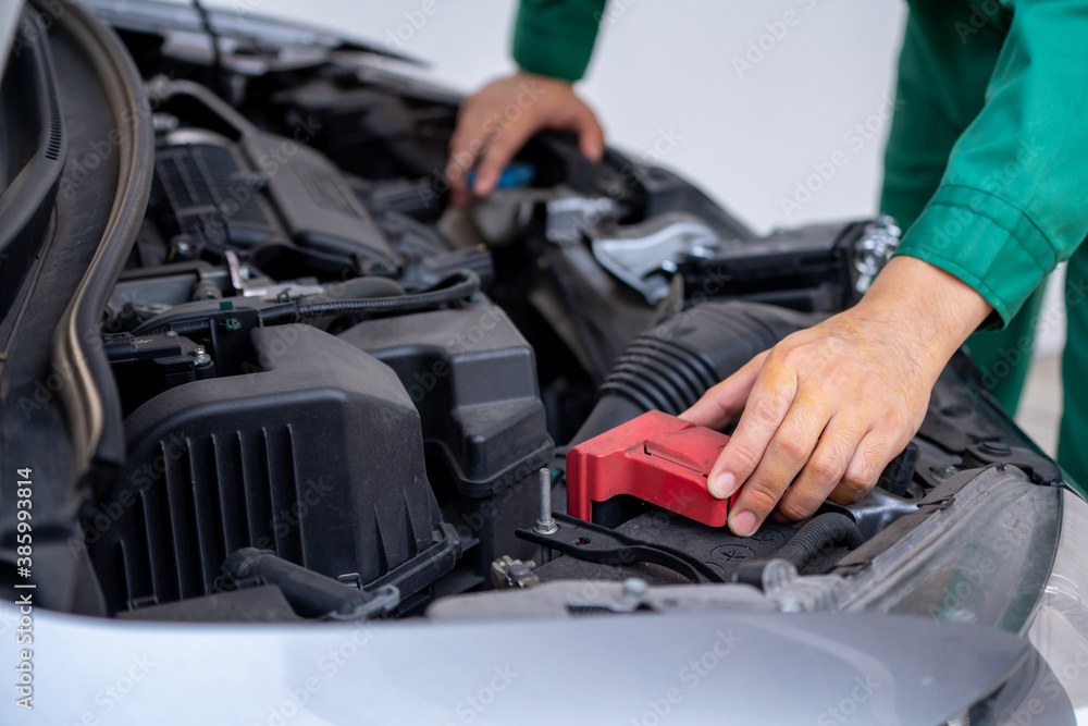 Professional mechanic hand providing car repair and maintenance service in auto garage. Car service 