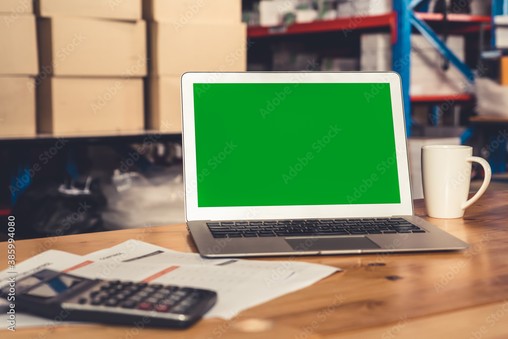 Computer with green screen display in warehouse storage room . Delivery and transportation software 