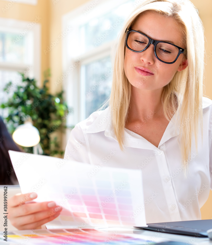 Graphic designer using her graphic tablet in an office