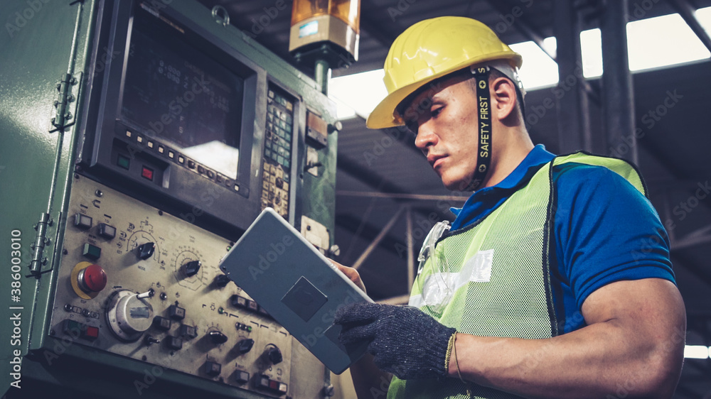 Smart factory worker using machine in factory workshop . Industry and engineering concept.