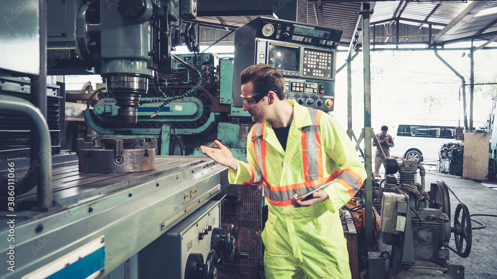 Smart factory worker using machine in factory workshop . Industry and engineering concept.