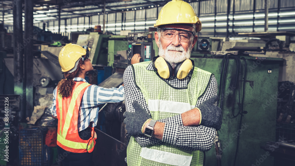 Senior factory worker or engineer close up portrait in factory . Industry and engineering concept .