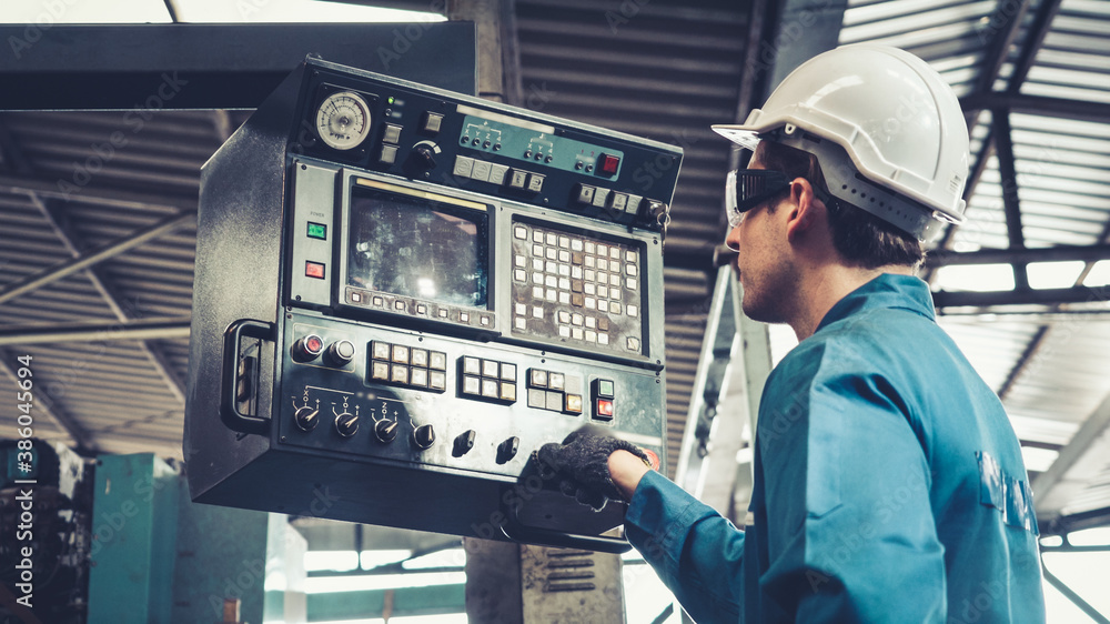 Smart factory worker using machine in factory workshop . Industry and engineering concept.