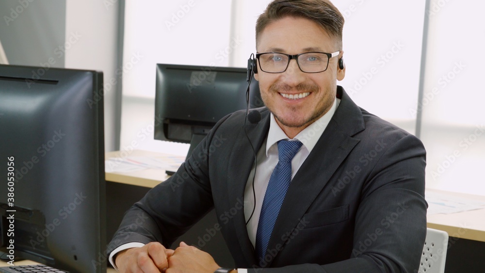 Business people wearing headset working in office to support remote customer or colleague. Call cent