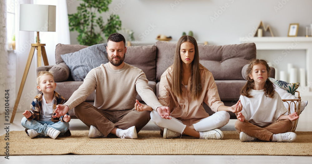 happy healthy family meditates at home.