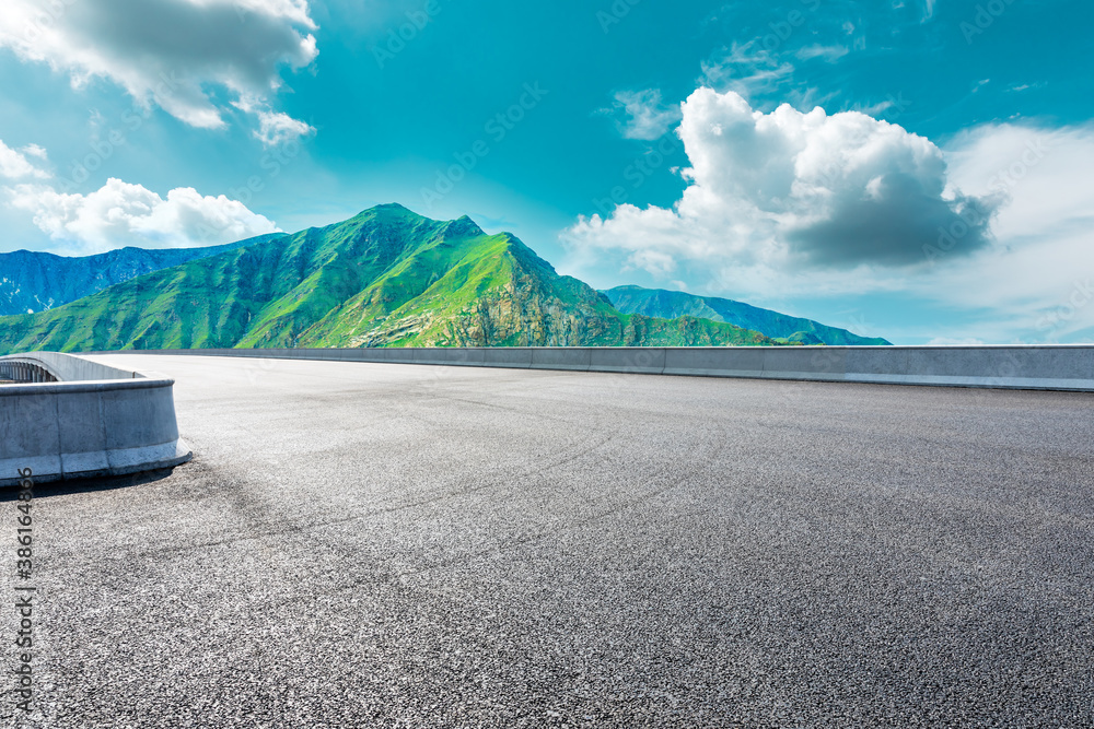 New asphalt road and green mountain with sky cloud natural scenery.