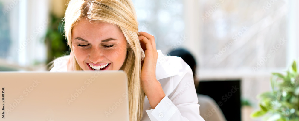 Young woman sitting at her desk in an office