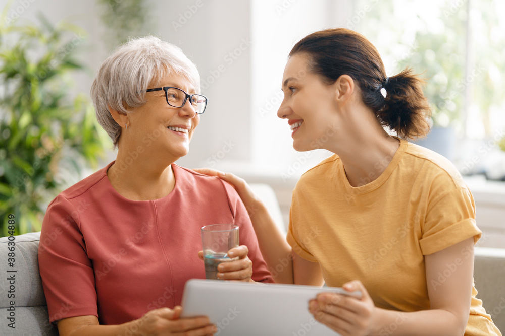 Young and senior women are using laptop