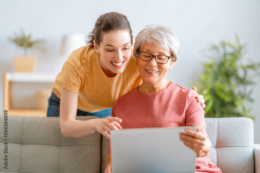 Young and senior women are using laptop