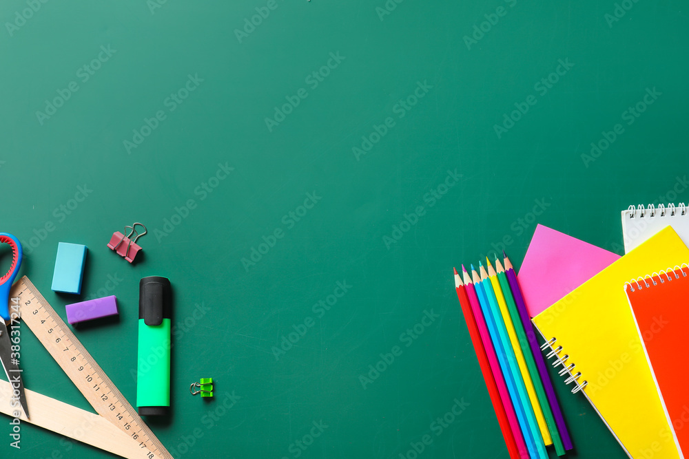 Set of school stationery on blackboard