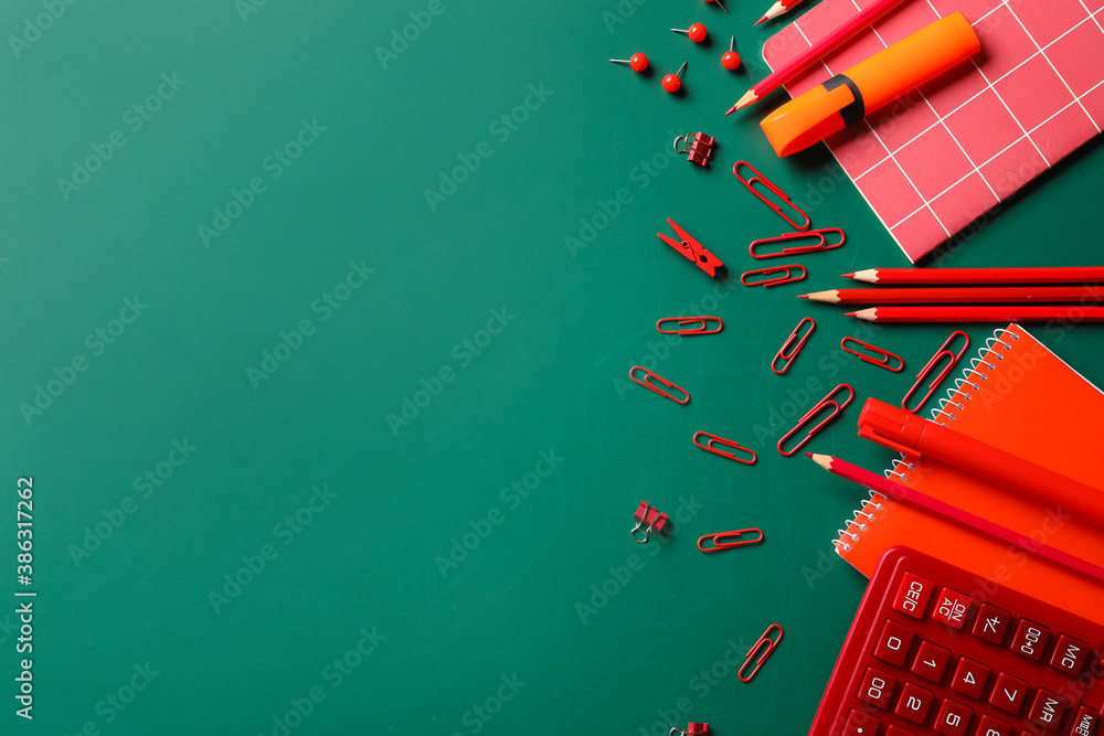 Set of school stationery on blackboard