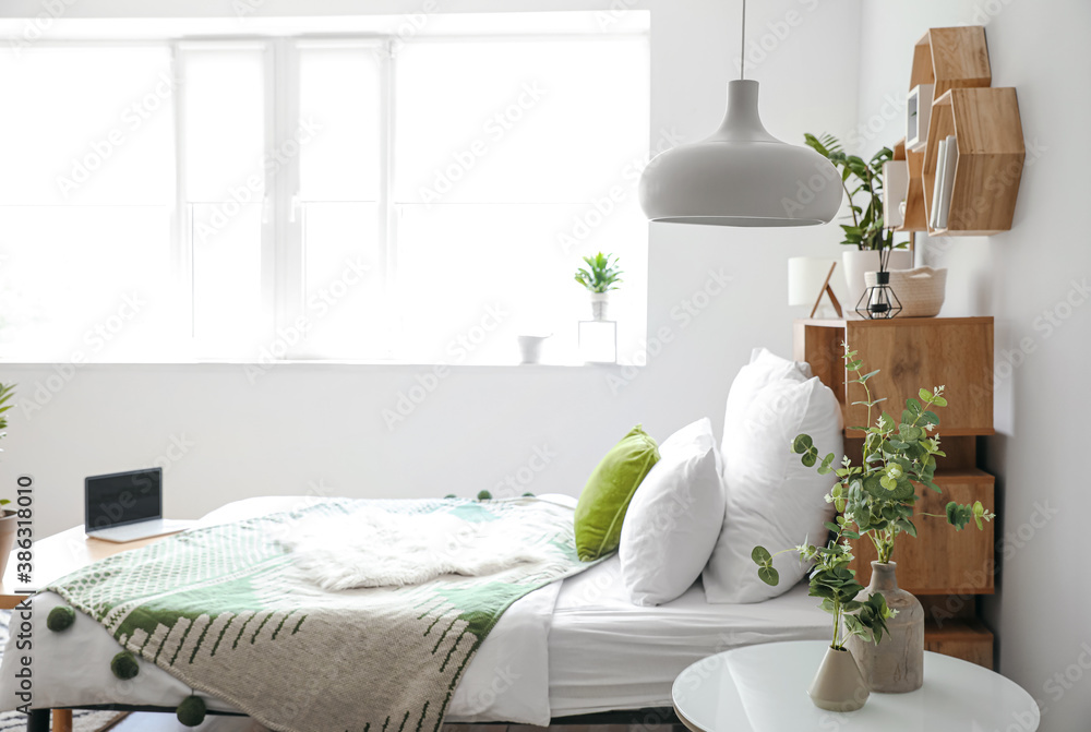 Interior of modern stylish bedroom with shelves