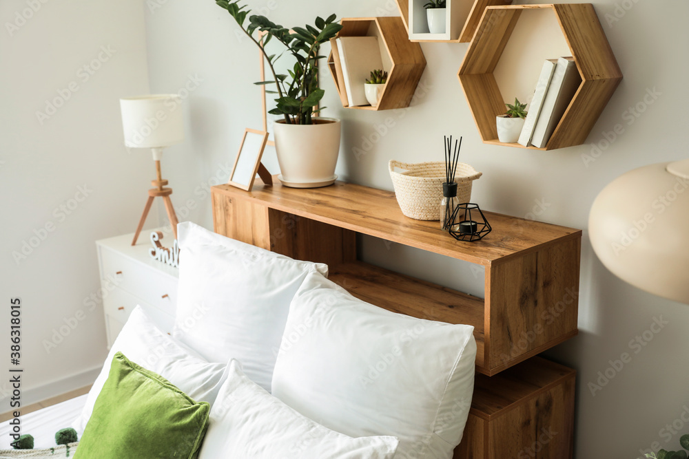 Interior of modern stylish bedroom with shelves