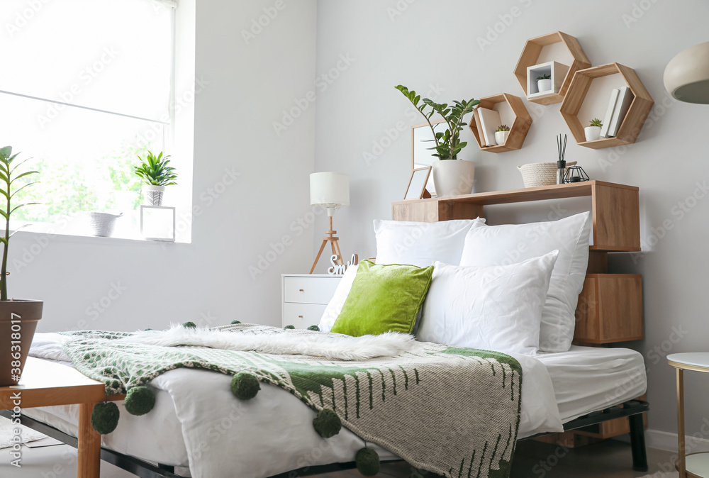 Interior of modern stylish bedroom with shelves