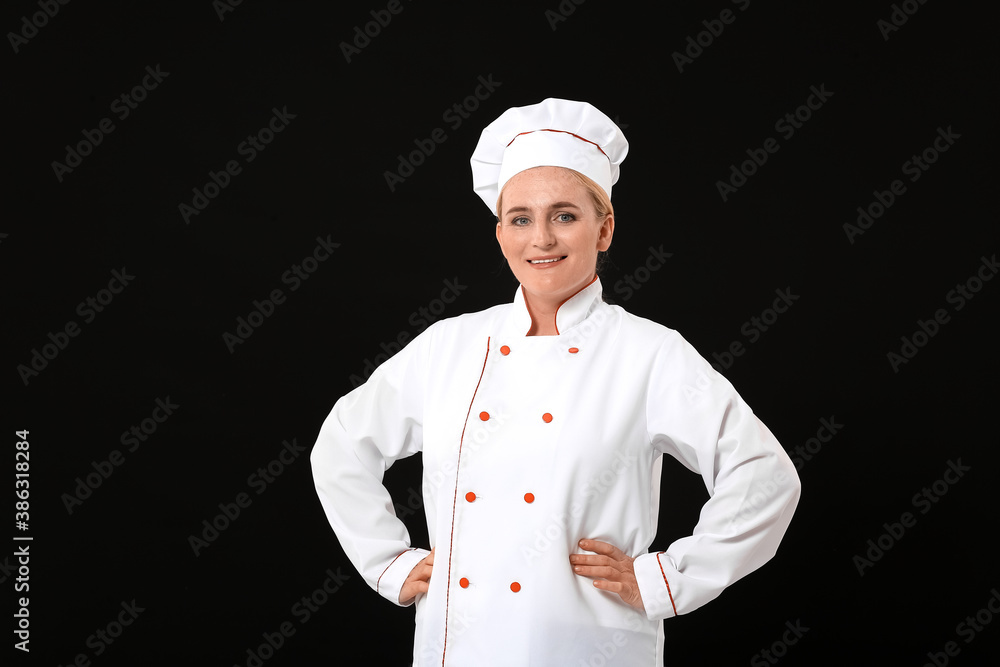 Mature female chef on dark background